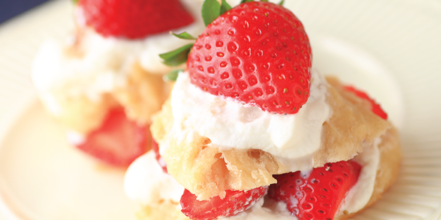 Strawberry shortcake with whipped cream on plate