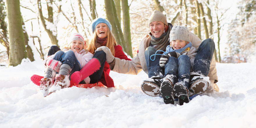 Family sledding in snow