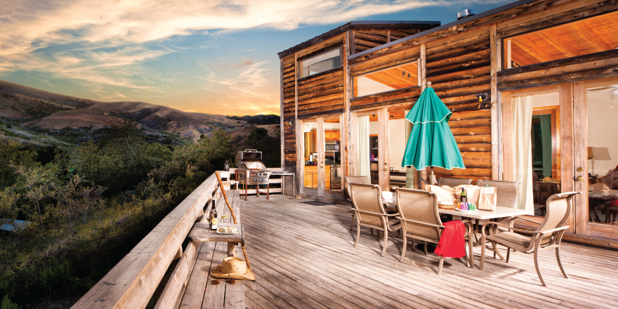 Deck with table and chairs looking over mountains