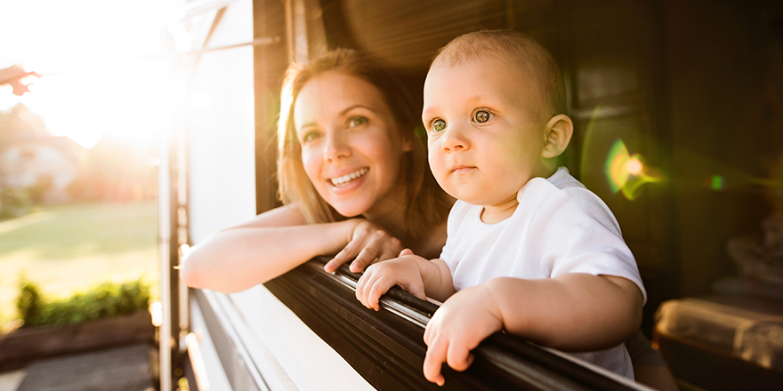 Mom with baby looking out RV