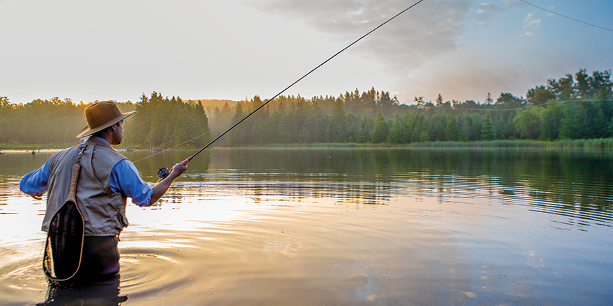 Man fly fishing standing in water