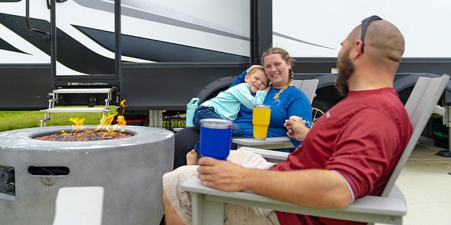 Family sitting around campfire