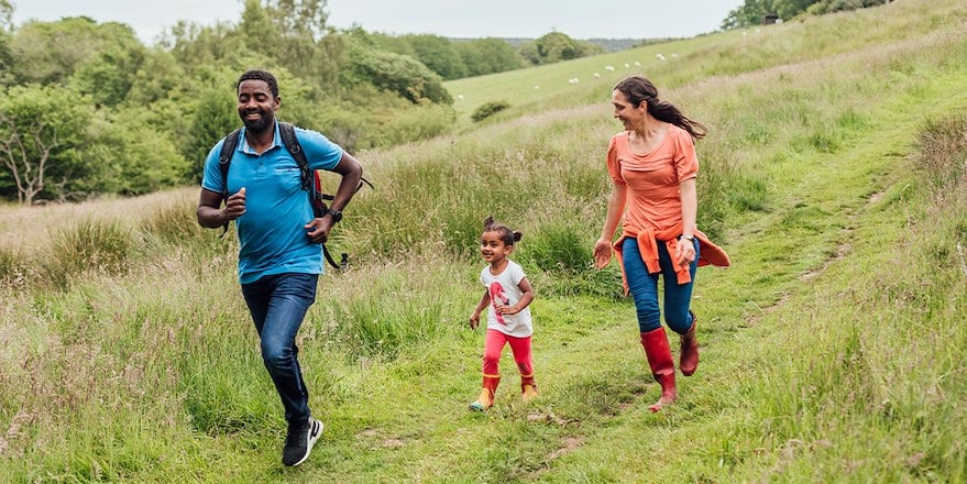 Family running in a field