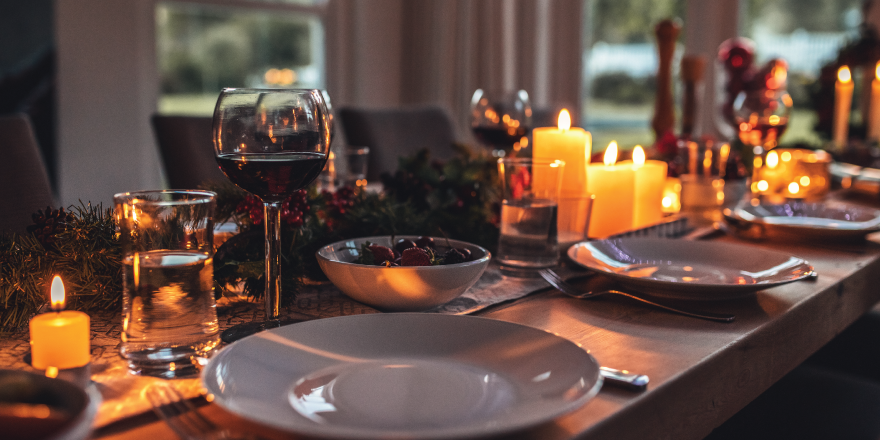 Dining table decorated with plates and candles