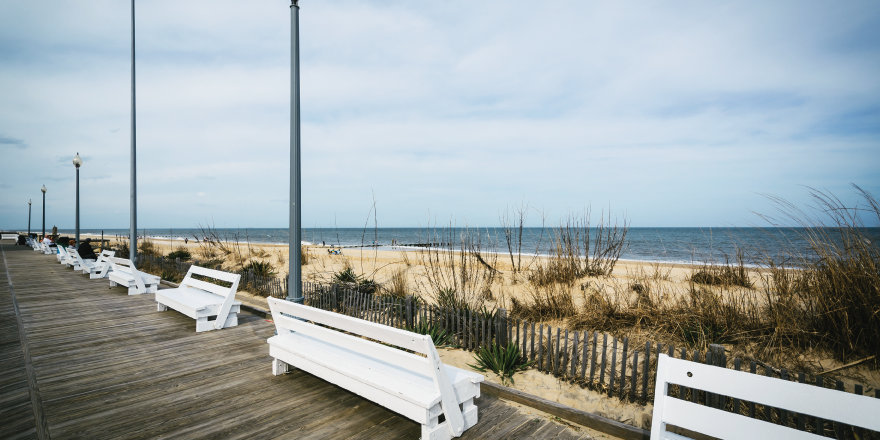 Boardwalk and benches overlooking sandy beach and water