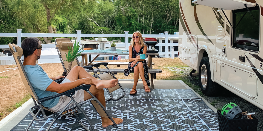 Couple sitting outside RV