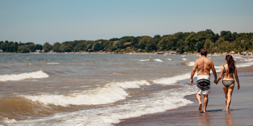 Couple strolling on beach near water