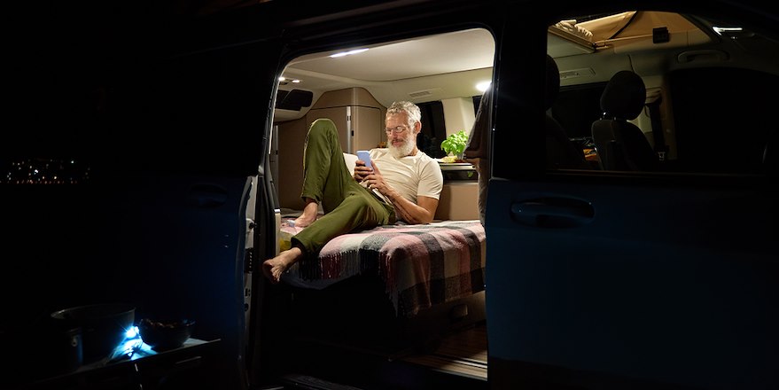 Man laying in bed in RV