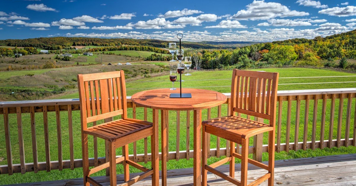 table and chairs overlooking vineyard